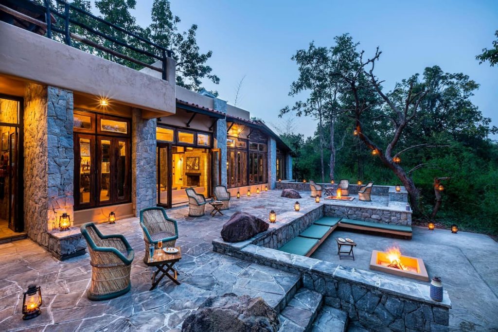 Luxury jungle resort at Kanha National Park with outdoor seating, fire pits, and forest view