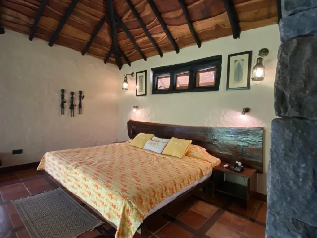 Luxury jungle resort bedroom in Madhya Pradesh with rustic decor and cozy ambience