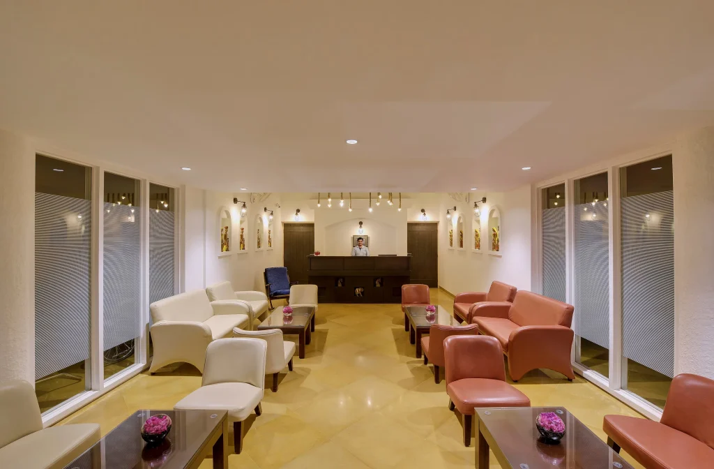 Elegant hotel lobby with cozy seating at MP Jungle Safari resort – perfect stay before Kanha and Pench tiger safari